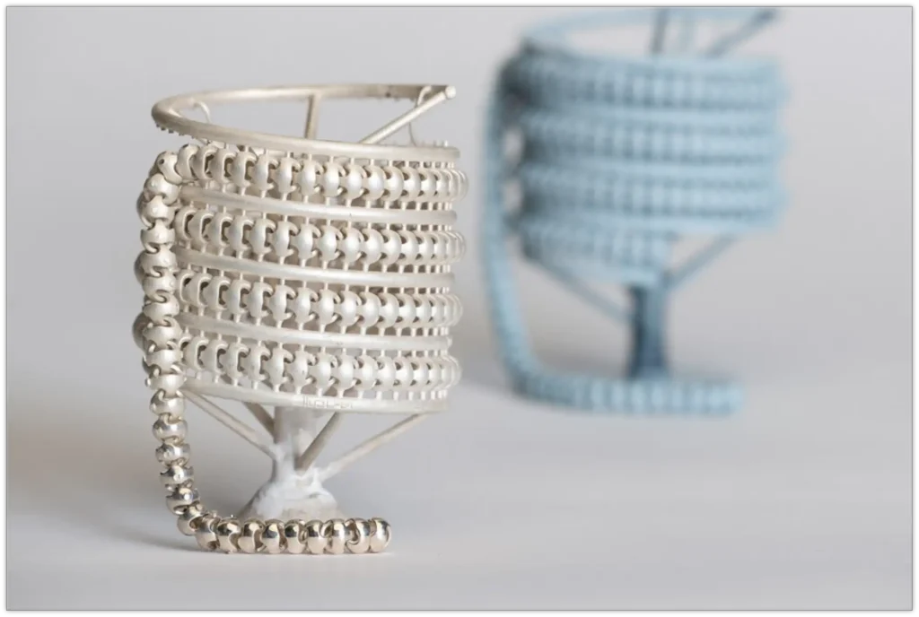 A chain direct casted kept next to the 3D printed model used for the casting.