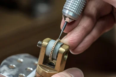 Artisan Setting Stones in a ring Jewelry artisan using precision tools to set diamonds in gold ring held in a vice clamp